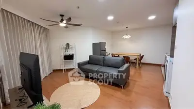 Spacious modern living room with sleek furniture and open dining area, perfect for entertaining.