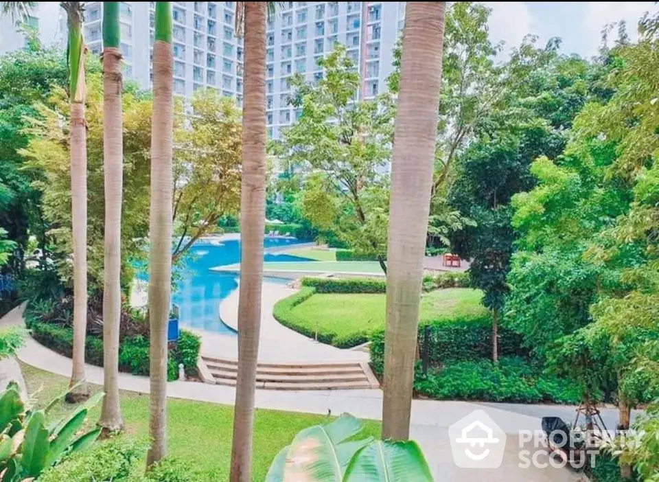 Luxurious residential complex with lush garden and inviting pool area