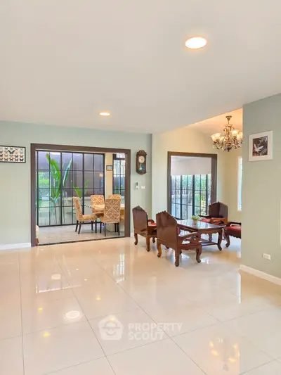 Spacious living room with elegant dining area and large windows for natural light.