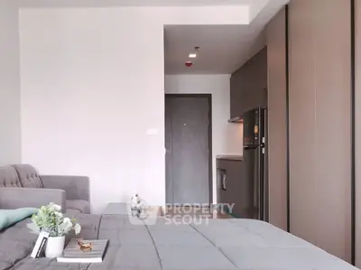 Modern studio apartment with cozy living area and sleek kitchen design.