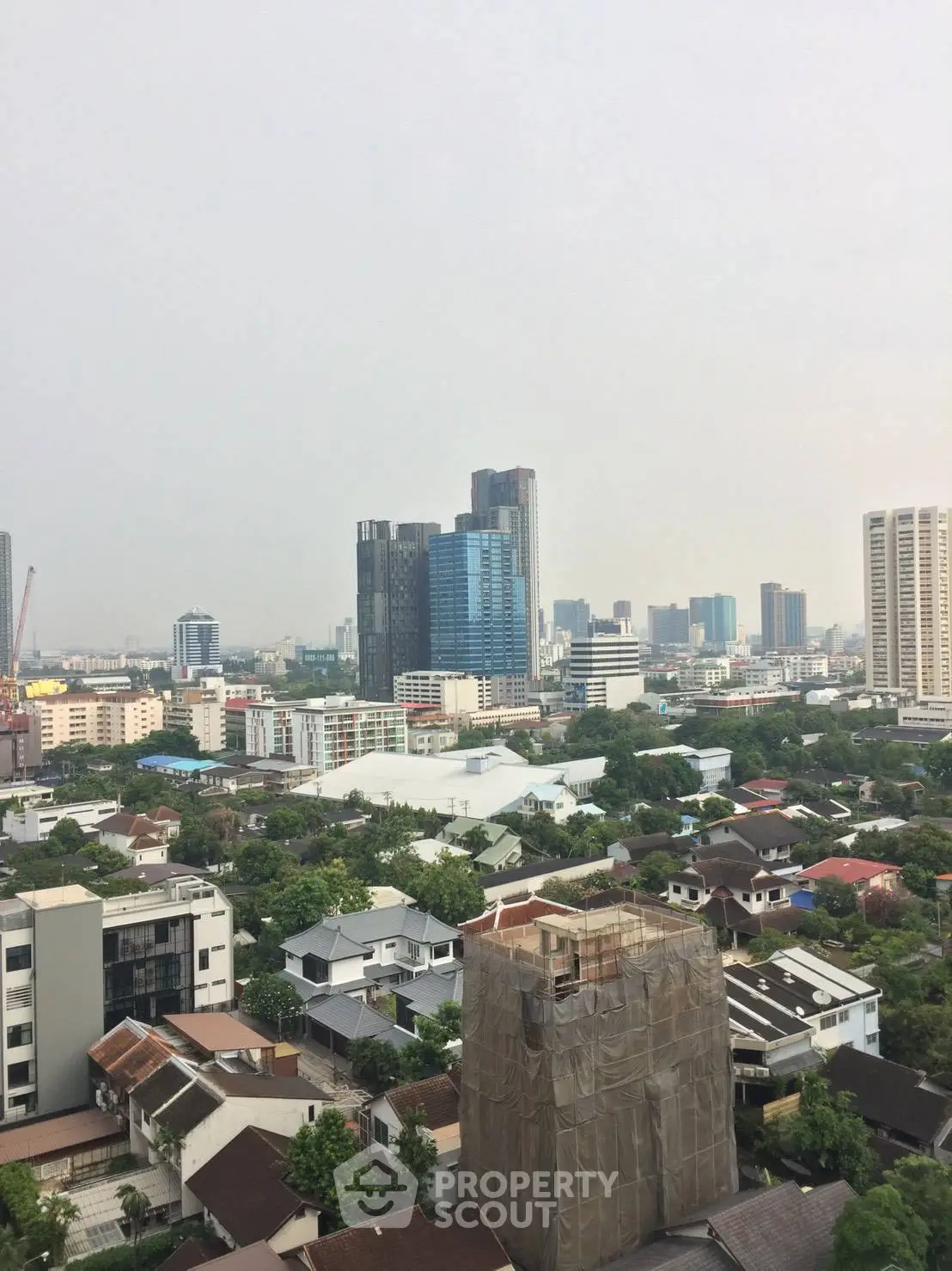 Stunning cityscape view with modern skyscrapers and lush greenery, perfect for urban living.