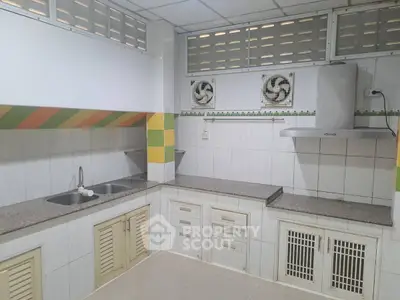 Spacious kitchen with modern appliances and ample storage space.