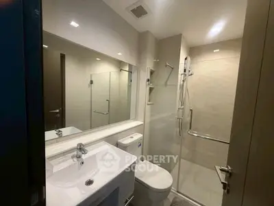 Modern bathroom with sleek fixtures and glass shower enclosure