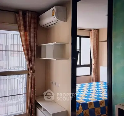 Cozy bedroom with air conditioning and modern shelving in a bright apartment.