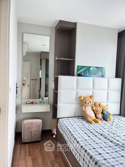 Cozy bedroom with plush toys and modern decor, perfect for a child's room.