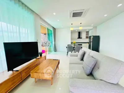 Modern open-plan living room with sleek kitchen and stylish furniture