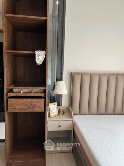 Modern bedroom with stylish headboard and wooden shelving unit