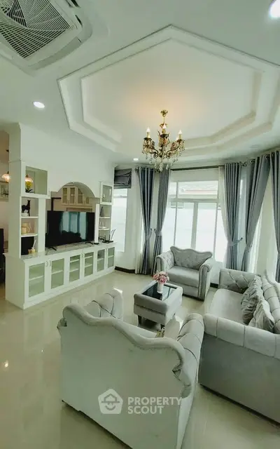 Elegant living room with chandelier and large windows in modern home