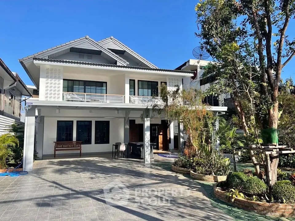 Charming two-story house with spacious driveway and lush garden in a serene neighborhood.