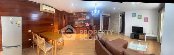 Spacious open-plan living room with modern kitchen and stylish decor