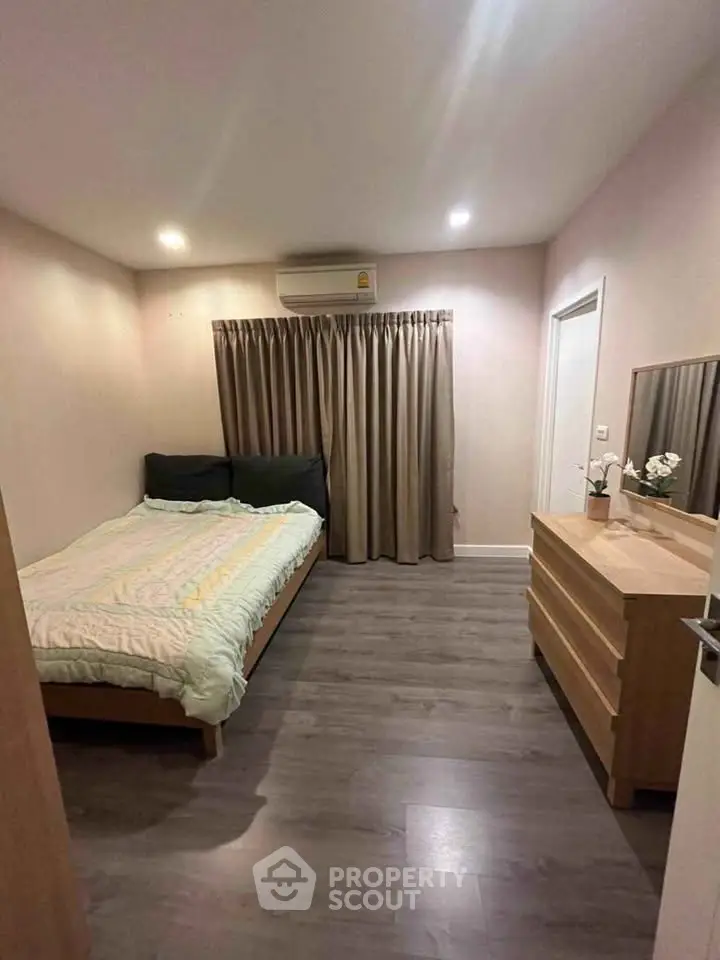 Cozy bedroom with modern decor and wooden flooring