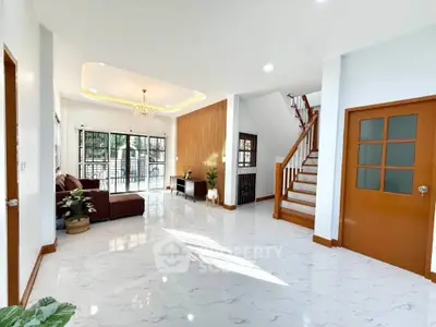Spacious modern living room with elegant staircase and natural light