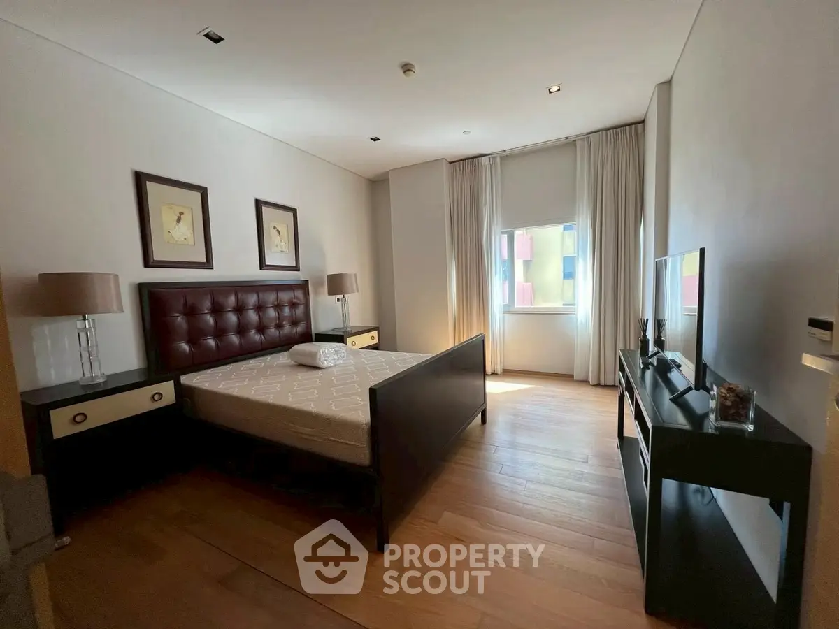 Spacious bedroom with elegant decor and natural light