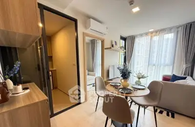 Modern living room with dining area and large windows in a stylish apartment