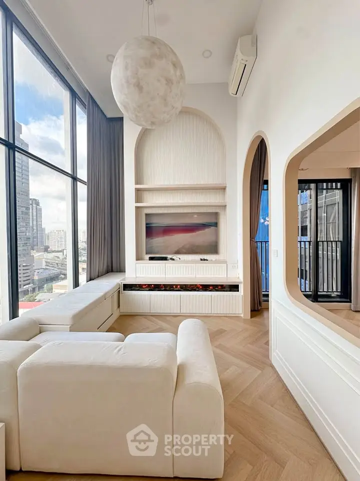 Luxurious modern living room with high ceilings and large windows offering stunning city views.