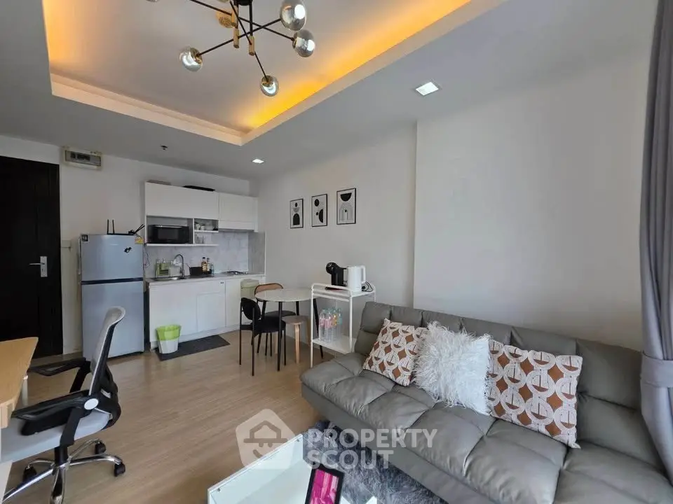 Modern living room with stylish decor and open kitchen layout in a cozy apartment.