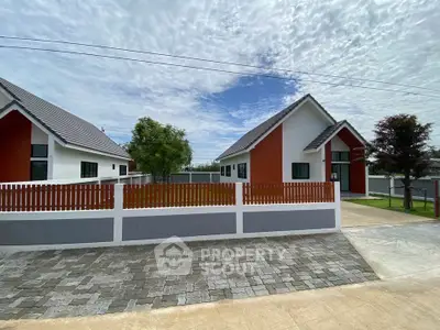 Modern suburban homes with sleek design and spacious driveways under a clear sky.