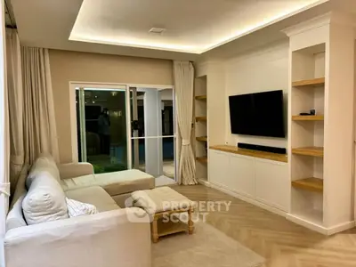 Elegant living room with modern decor, cozy sectional sofa, and built-in entertainment center.