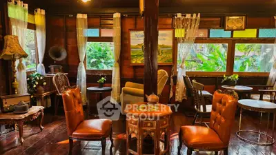 Charming vintage living room with wooden decor and lush garden view, perfect for cozy relaxation.
