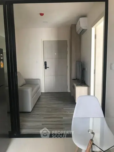 Modern living room with glass partition and sleek furniture