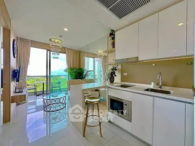 Modern open-layout kitchen and living room with balcony and scenic view