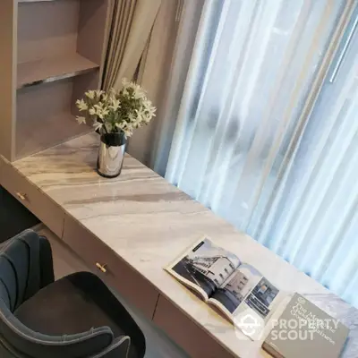 Elegant study area with marble desk and plush chair, perfect for productivity and style.