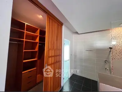 Spacious bathroom with walk-in closet and modern shower design