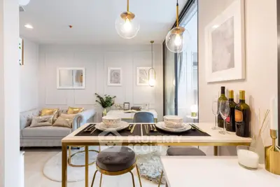 Modern open-plan living and dining area with elegant decor and stylish lighting.