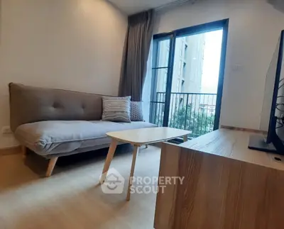 Modern living room with cozy sofa and balcony view in urban apartment