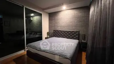 Modern bedroom with stylish decor and cozy ambiance, featuring a plush bed and elegant lighting.