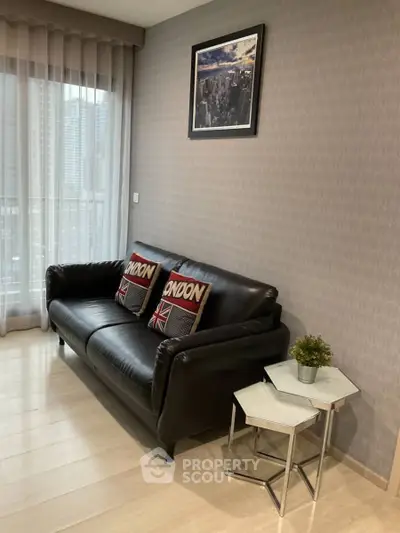 Stylish living room with modern decor and city view, featuring a cozy leather sofa and chic side tables.