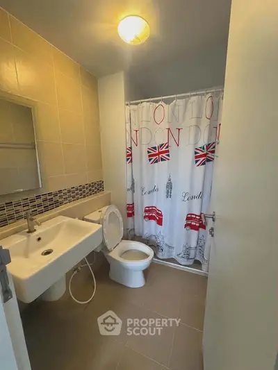 Modern bathroom with London-themed shower curtain and sleek fixtures.