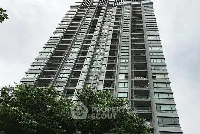 Stunning high-rise building with modern architecture and lush greenery, perfect for urban living.