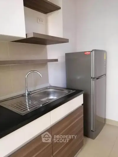 Modern kitchen with sleek cabinets and stainless steel fridge