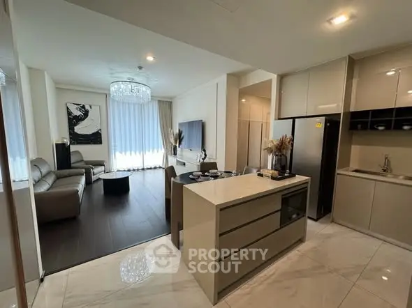 Luxurious open-plan living room and kitchen with modern decor and elegant lighting.