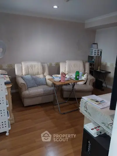 Cozy living room with leather sofas and wooden flooring