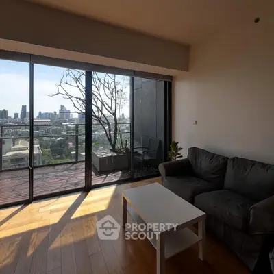 Modern living room with stunning city view and spacious balcony access.