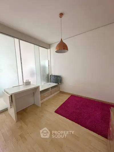 Minimalist study room with wooden flooring and modern lighting