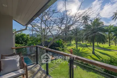 Stunning balcony view overlooking lush tropical garden and palm trees