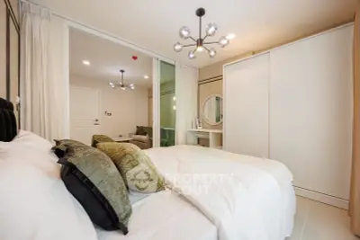 Modern bedroom with stylish lighting and spacious wardrobe in a contemporary apartment.