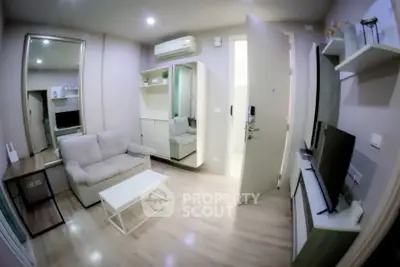 Modern living room with cozy sofa, TV, and stylish decor in a compact apartment.