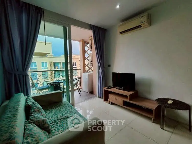 Cozy living room with balcony access and air conditioning in modern apartment.