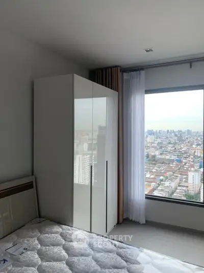 Modern bedroom with city view and sleek wardrobe
