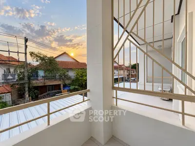 Spacious balcony with sunset view in modern residential area, perfect for relaxation and enjoying the outdoors.