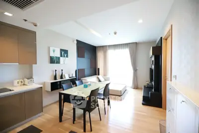 Modern open-plan living room with sleek kitchen and stylish decor