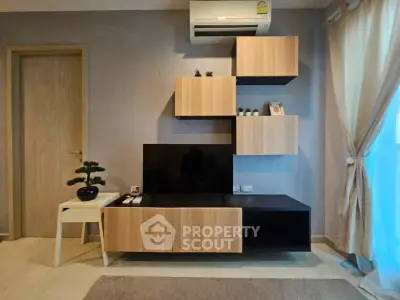 Modern living room with stylish wooden TV cabinet and air conditioning unit.