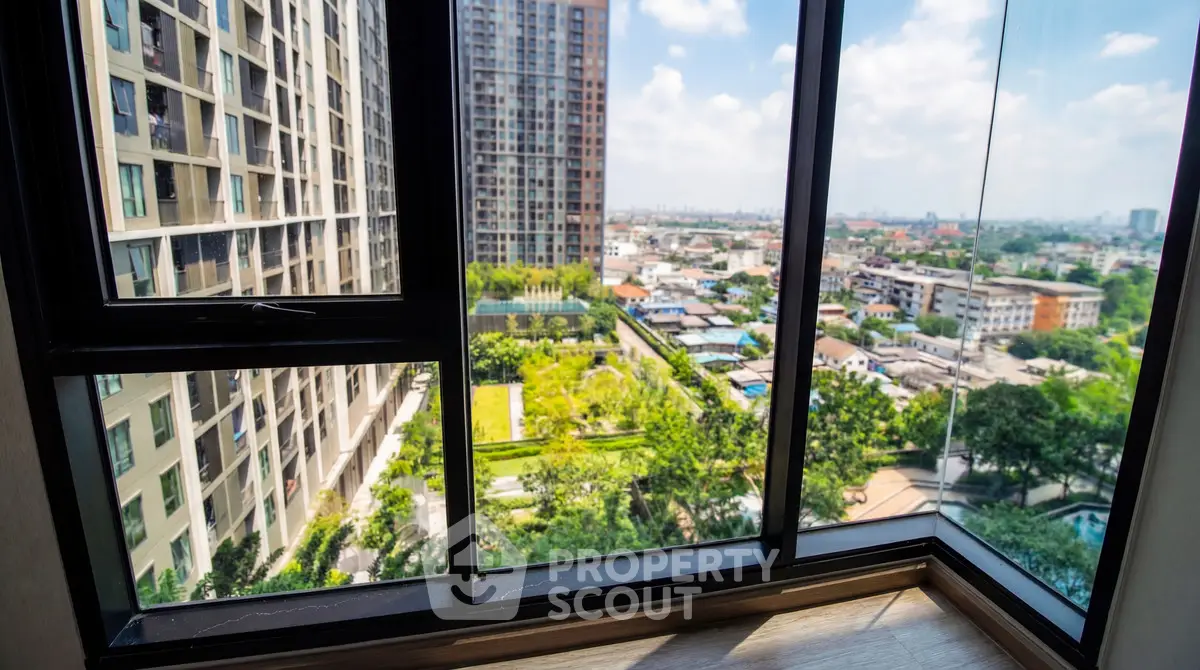 Stunning high-rise apartment view with expansive cityscape and lush greenery.