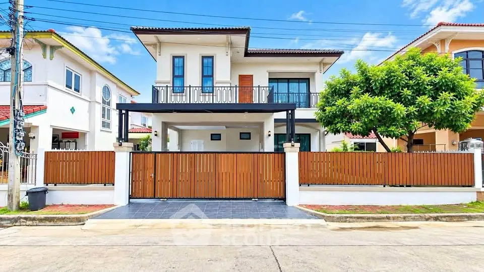 Stunning modern two-story house with elegant facade and spacious front yard in a serene neighborhood.