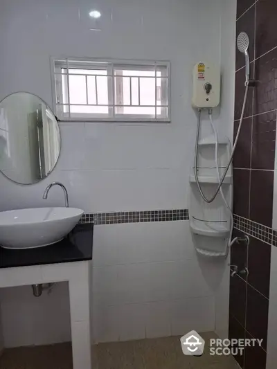 Modern bathroom with sleek fixtures and wall-mounted shower unit