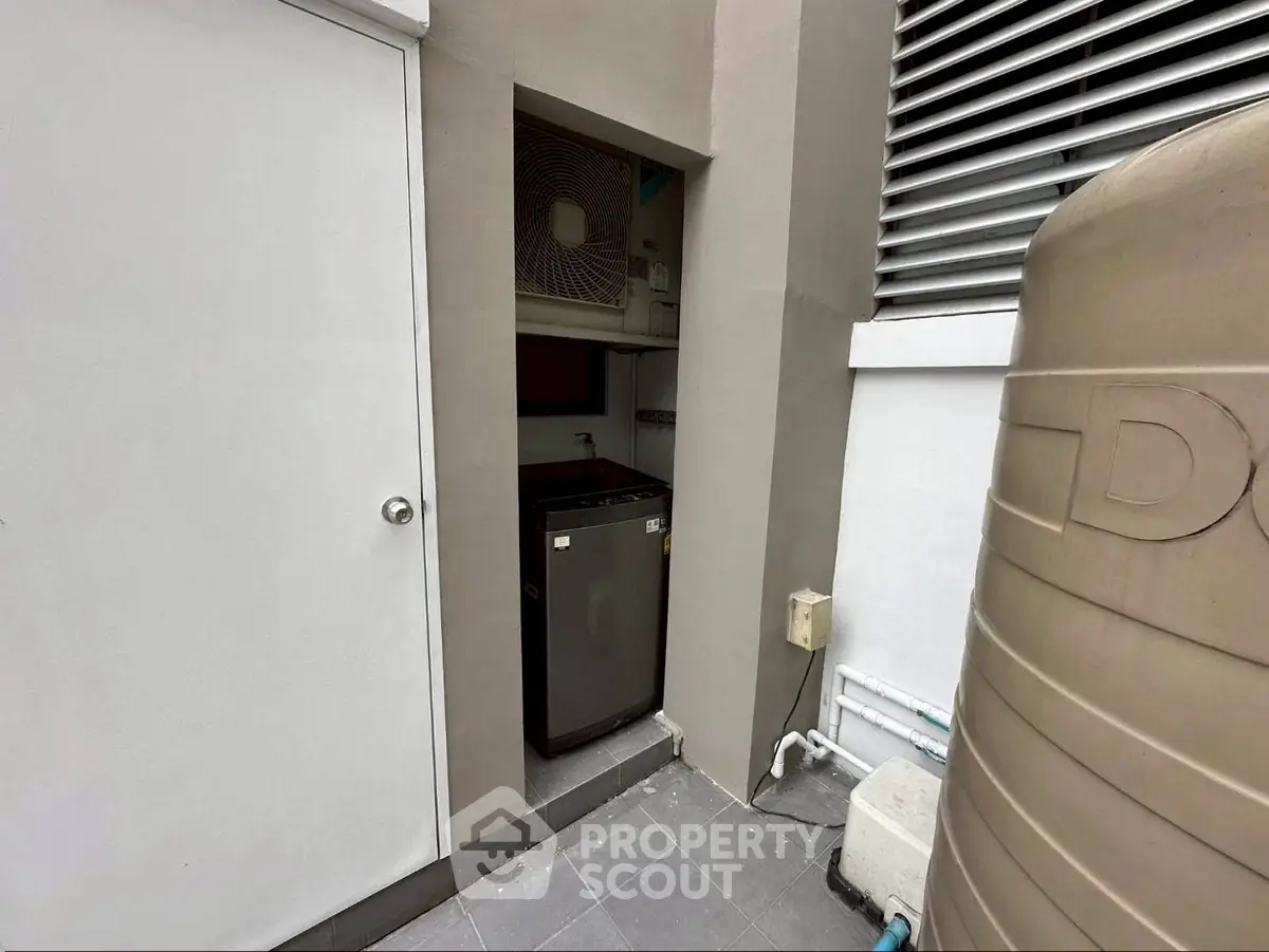 Compact outdoor utility area with storage and air conditioning unit